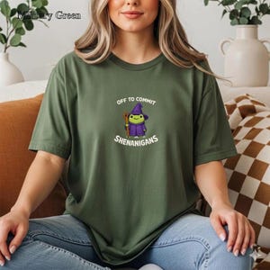 May include: A white ceramic mug with a black handle and the text "But First, Coffee" in a bold, black font. The mug is set against a blurred background, suggesting a cozy setting. The mug appears to be approximately 4 inches tall.