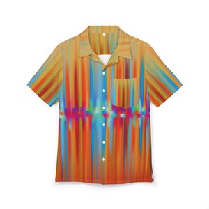 May include: Short-sleeved button-down shirt with a vibrant, abstract design. The shirt features a colorful vertical stripe pattern in shades of orange, blue, yellow, and purple. It has a chest pocket and a classic collar, perfect for casual wear.