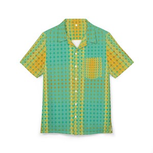 May include: Short-sleeved button-up shirt with a teal and yellow geometric pattern. The shirt features a camp collar, a chest pocket, and a button-down front. The pattern consists of overlapping circles in shades of teal and yellow.