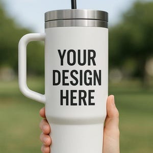 A person's hand holding a large white mug with the text "YOUR DESIGN HERE" printed on it.