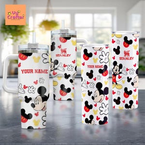 a collection of Mickey Mouse-themed mugs and tumblers, each with a personalized name printed on them.