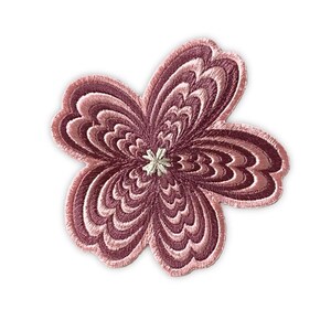 May include: Embroidered floral applique in shades of mauve and pink. The flower has a layered petal design with a light beige center. This decorative patch can be used to embellish clothing, bags, or other fabric items.