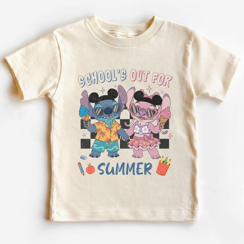 May include: Cream-colored t-shirt featuring a cartoon illustration of two characters, one blue and one pink, holding ice cream cones. The text "SCHOOL'S OUT FOR SUMMER" is above the characters.