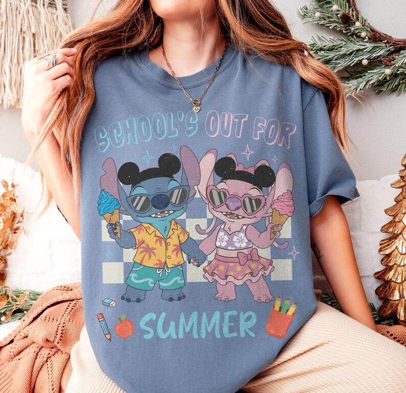 May include: A blue t-shirt with the text "SCHOOL'S OUT FOR SUMMER" and a cartoon graphic of two characters holding ice cream cones. One character is blue and the other is pink. The shirt has a checkered background.