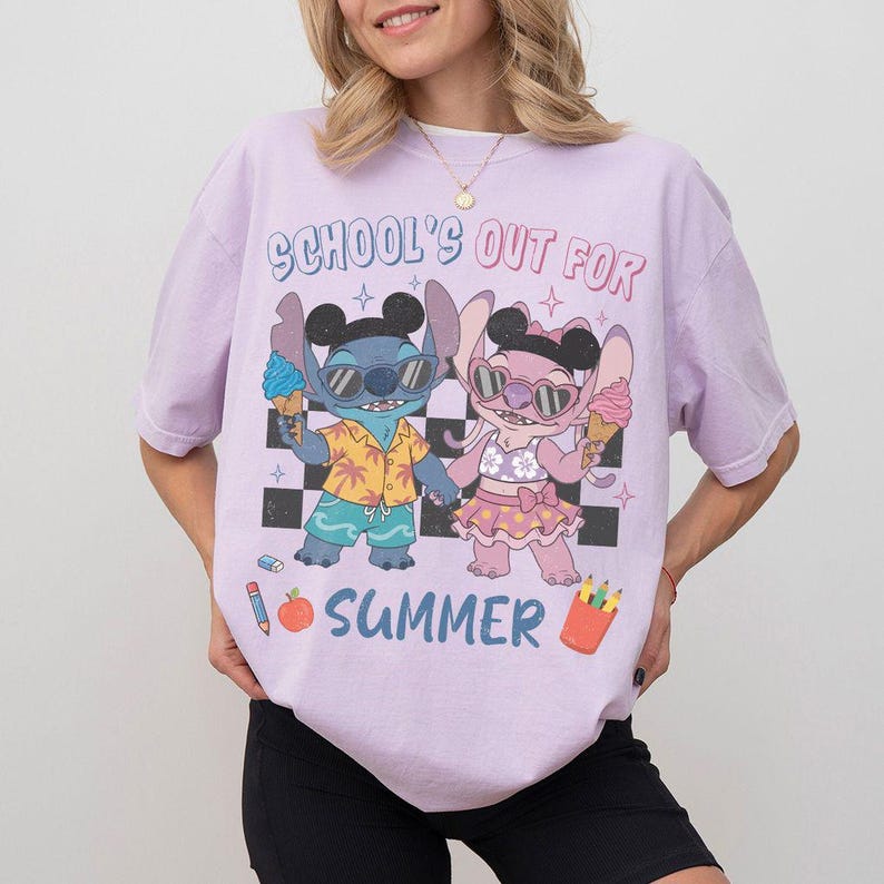May include: A light purple t-shirt with a graphic of two cartoon characters holding ice cream cones. The text "SCHOOL'S OUT FOR SUMMER" is above the characters. The characters are on a black and white checkered background.