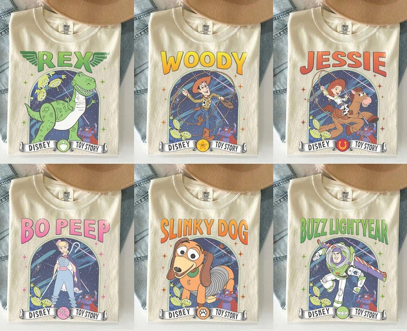 May include: Six cream-coloured t-shirts featuring characters from Disney's Toy Story. Each shirt displays a different character: Rex, Woody, Jessie, Bo Peep, Slinky Dog, and Buzz Lightyear, with the Disney Toy Story logo.
