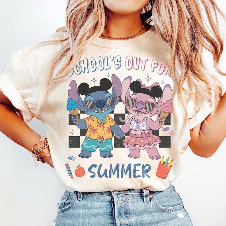 May include: Cream-colored t-shirt featuring a cartoon illustration of two characters holding ice cream cones. The characters are wearing sunglasses and summer attire. The text "SCHOOL'S OUT FOR SUMMER" is printed above the characters.