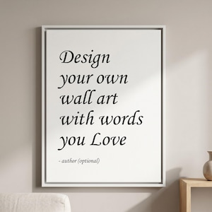 Może przedstawiać: Prostokątny biały wydruk ścienny w cienkiej białej ramie z czarnym tekstem: Design your own wall art with words you Love - author (optional). Typografia łączy style szeryfowe z kursywą przypominającą pismo odręczne.