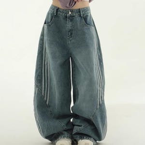 Baggy Wide Leg Jeans | Retro Oversized Pants | Spliced Denim Trousers | Alternative Y2K Grunge Streetwear
.
Women's oversized wide-leg denim pants with spliced striped detailing, baggy streetwear jeans in retro Y2K fashion style, perfect for alternative and casual outfits.