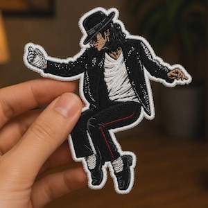 May include: An embroidered patch featuring a figure in a black fedora, black jacket with white accents, white shirt, and black trousers with a thin red side stripe. The figure is depicted in a dynamic dancing pose with one white gloved hand extended.