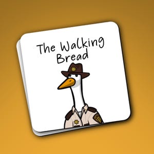 May include: A square white coaster featuring a cartoon illustration of a goose wearing a brown sheriff hat and a tan uniform shirt. Above the goose, the text reads The Walking Bread in black, handwritten-style lettering on a white background.