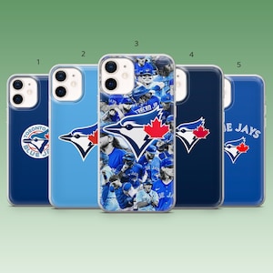May include: Five phone cases in shades of blue. Each case features a Toronto Blue Jays logo, with some displaying the team's name or a collage of players. The cases are designed for a smartphone.