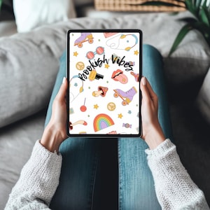 May include: A tablet displaying a colorful pattern with the words "Bookish Vibes." The design includes roller skates, sunglasses, a rainbow, and other retro-style illustrations on a white background. The tablet is held by a person wearing a gray sweater and blue jeans.