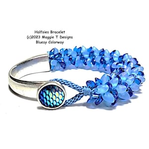 May include: A blue beaded bracelet with a silver clasp and a decorative button. The bracelet is made of small, light blue beads and is labelled "Halfies Bracelet Bluesy Colorway."