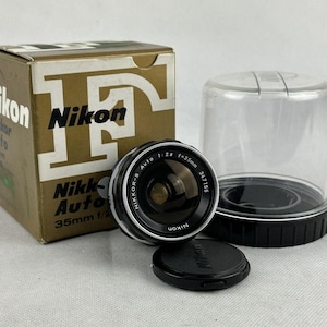 A Nikon NIKKOR-S 35mm f2.8 lens with its original box.