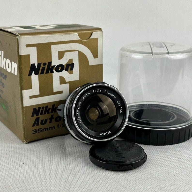 A Nikon NIKKOR-S 35mm f2.8 lens with its original box.