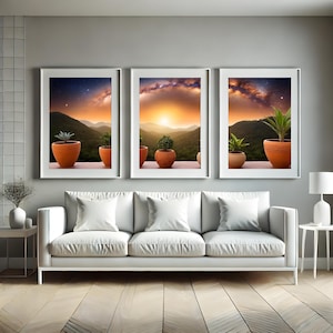 Puede incluir: Tres impresiones enmarcadas de paisajes con una puesta de sol sobre montañas, cada una con una planta en maceta en una maceta de terracota. Las impresiones se exhiben sobre un sofá blanco en un salón moderno.