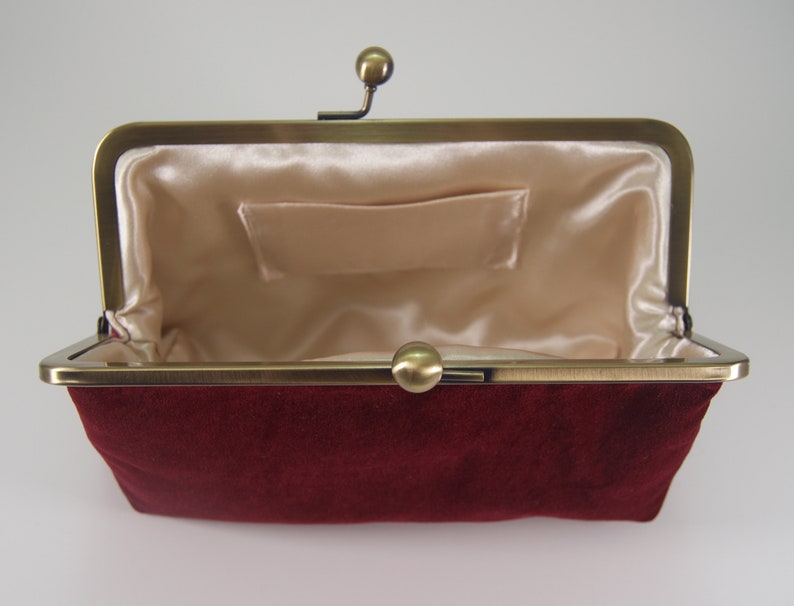 burgundy and gold clutch bag