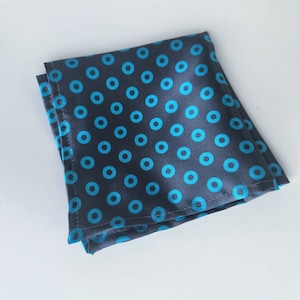 May include: A dark blue pocket square with a pattern of light blue circles.