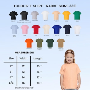 May include: A peach-coloured toddler t-shirt, size 5/6, with a width of 38 cm and a length of 47 cm. The image shows a range of t-shirt colours, including black, white, and navy.