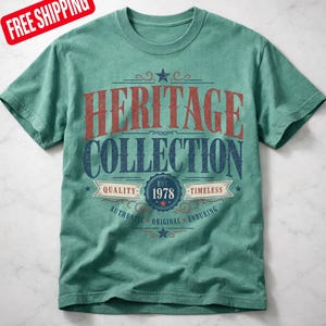 May include: A teal t-shirt with the words "HERITAGE COLLECTION" in red and blue lettering. The shirt also features the text "EST. 1978" and the words "QUALITY" and "TIMELESS".