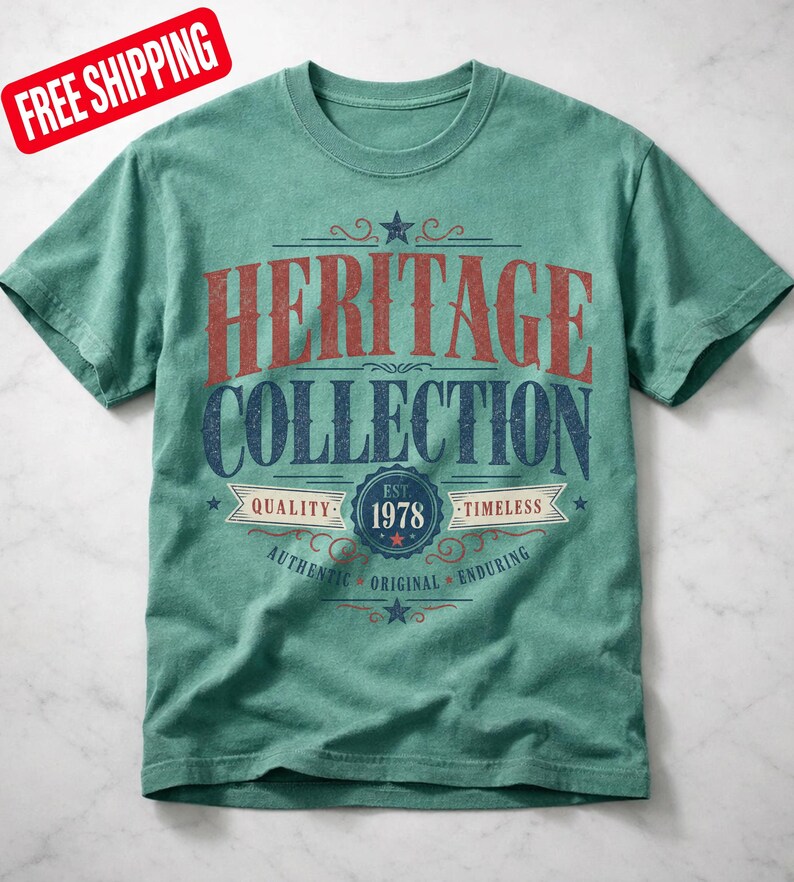 May include: A teal t-shirt with the words "HERITAGE COLLECTION" in red and blue lettering. The shirt also features the text "EST. 1978" and the words "QUALITY" and "TIMELESS".