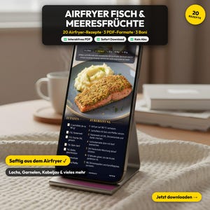 May include: A smartphone shows an air fryer fish and seafood recipe. The screen displays a salmon dish with mashed potatoes. The text includes ingredients and instructions. The phone is in a silver stand, with text at the top and bottom of the screen.