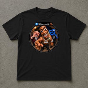 May include: A black short-sleeve t-shirt featuring a circular graphic print. The design shows a cartoon character labeled SAHUR, a pig labeled PORK, and a blue figure labeled 67, with a notification bar at the top reading There is motion at your front door.