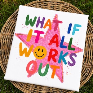 May include: A white square canvas featuring a large pink star with a gold outline. The text "WHAT IF IT ALL WORKS OUT" is printed in multi-colored, hand-drawn style letters over the star, with a yellow smiley face replacing the letter O.