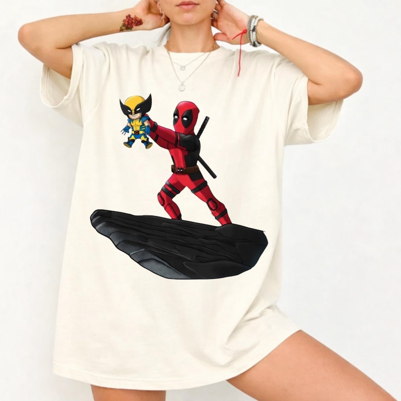 Unleash your inner anti-hero with this bold and playful Deadpool & Wolverine mashup T-Shirt! 🖤🔥 Combining the chaotic humor of Deadpool with the fierce energy of Wolverine, this design delivers a fun twist—perfectly blended with a nostalgic nod to The Lion King theme. 🦁✨