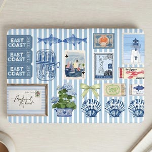 May include: A rectangular mat with a light blue and white vertical striped pattern featuring illustrations of East Coast tickets, fish, a playing card, stamps, a lighthouse, a lobster, a framed postcard, a hydrangea plant, a bow, and shells.
