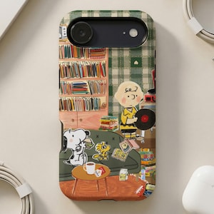 Peanuts characters on phone case with books, couch, and records.