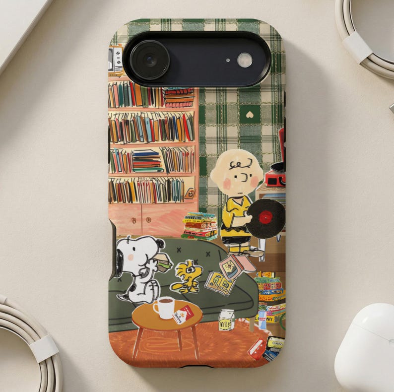 Peanuts characters on phone case with books, couch, and records.