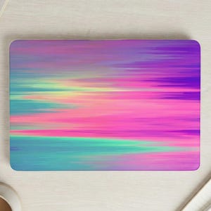 May include: Rectangular laptop skin with an abstract design of horizontal colour streaks. The colour palette includes pink, purple, teal, and yellow, creating a vibrant and artistic aesthetic.