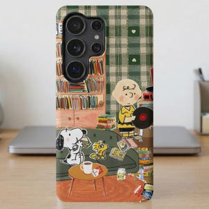 Snoopy and Charlie Brown in a room with bookshelves, records, and a vintage turntable.