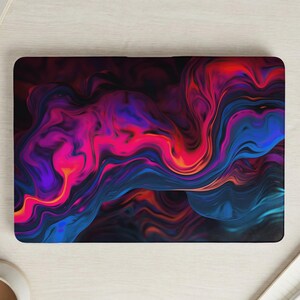 May include: Laptop skin featuring an abstract design with swirling patterns in shades of blue, purple, pink, and orange. The design has a dark background and a glossy finish. The laptop skin is rectangular and fits a standard laptop.