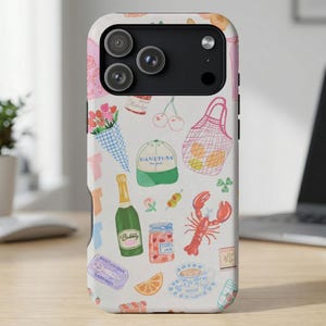 May include: White phone case with a colorful illustration of summer and vacation-themed items. The design includes a bouquet of flowers, cherries, a lobster, a bottle of champagne, and a Hamptons hat.