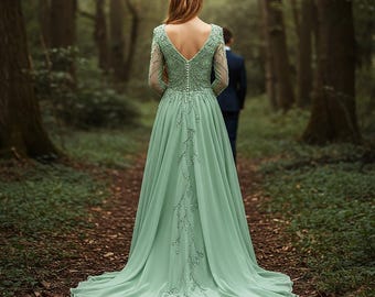 May include: A long, flowing sage green gown with a deep V-neck and long sleeves. The dress features intricate beaded detailing down the back and sleeves. A gold-colored crown adorns the person's head. The scene is set in a forest.