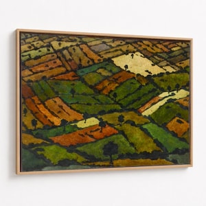 May include: An abstract landscape painting in a wooden frame. The artwork depicts a patchwork of fields in shades of green, orange, yellow, and brown, with small trees scattered throughout. The painting has a textured appearance.