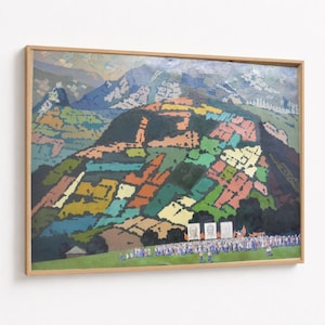 May include: A framed abstract landscape painting. The artwork features a colourful hillside with patches of green, orange, and pink. A crowd of people stands at the base of the hill, with mountains in the background. The frame is light wood.
