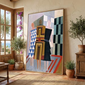 May include: Large framed artwork featuring three figures in geometric dresses. The dresses are in shades of blue, yellow, and black. The background includes checkered patterns and a red and gray rug. The artwork is displayed in a room with a wooden door and potted plants.