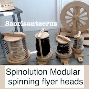 May include: Four wooden spinning flyer heads with different colored wool fibers. The flyer heads are part of a modular spinning wheel system. The text "Spinolution Modular spinning flyer heads" is at the bottom of the image.