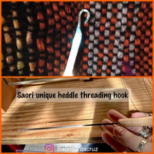 May include: A Saori unique heddle threading hook with a wooden handle. The hook is silver and has a curved end. The text "Saori unique heddle threading hook" is visible. The background shows woven fabric.
