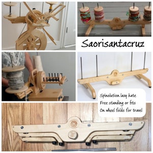 May include: A wooden spinning wheel with a lazy kate stand. The spinning wheel has a large wooden wheel and a smaller wheel with a spindle. The lazy kate stand is a wooden frame with three spindles. The spinning wheel and lazy kate stand are both made of natural wood.
