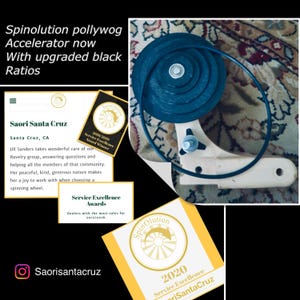 May include: A black and white image of a spinning wheel with a black wheel and a wooden base. The wheel is labeled "Spinolution pollywog Accelerator now with upgraded black Ratios". The image also includes a business card with the text "Saori Santa Cruz" and "Service Excellence Awards 2018/2019 Award Winner".