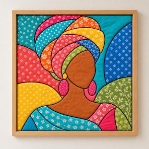 May include: A square framed fabric wall art piece featuring a stylized silhouette of a person with brown skin wearing a vibrant, multi-colored headwrap and large pink earrings. The background consists of various patterned fabric patches.