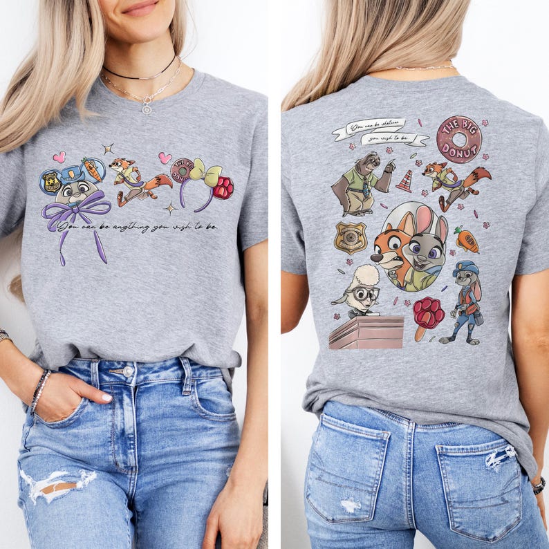 May include: A heather gray t-shirt featuring Zootopia character graphics. The front displays a bunny face with ears, a fox, and the text "You can be anything you wish to be." The back shows a collage of characters, a badge, and a donut graphic.