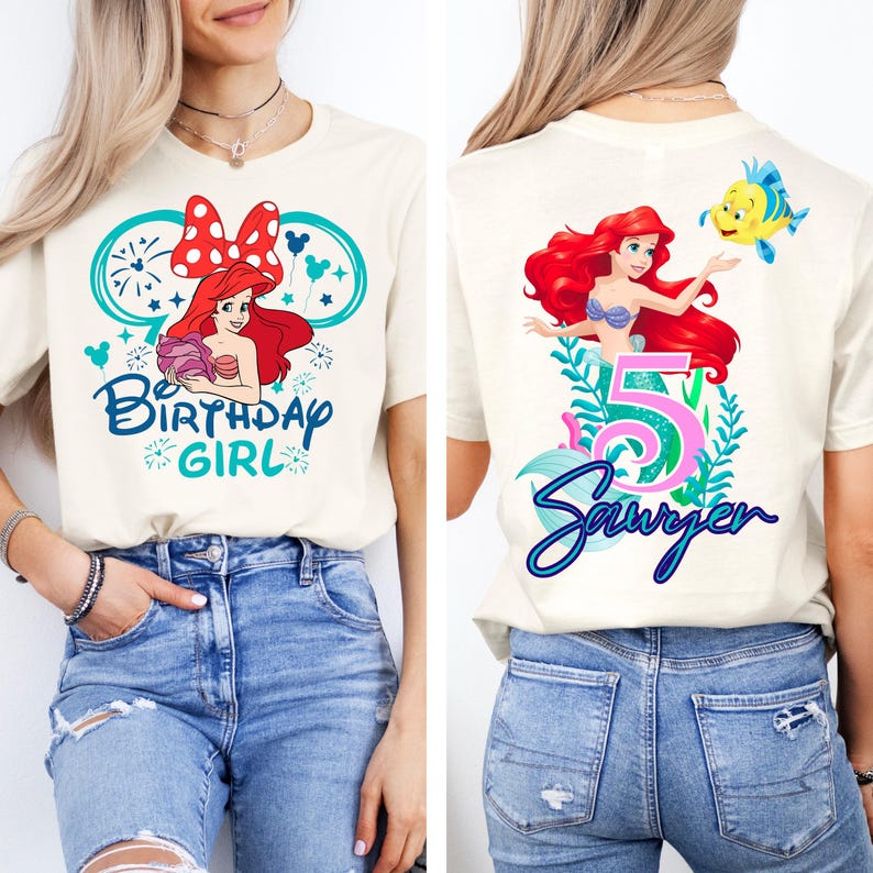 May include: Cream-colored t-shirt featuring a colorful graphic of a cartoon mermaid with red hair, a blue top, and a yellow fish. The front says "Birthday Girl" and the back says "5 Sawyer".