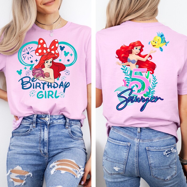 May include: A light purple t-shirt featuring a graphic of Ariel from The Little Mermaid with the text "Birthday Girl" on the front. The back of the shirt has Ariel, the number 5, and the name "Sawyer".