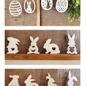 Peut inclure: Décorations de Pâques en bois blanc, comprenant des formes d'œufs et de lapins, certaines avec des découpes en forme de cœur. Les ornements en forme d'œuf mesurent 8 cm de large et 11 cm de haut. Les figurines de lapin mesurent 3 cm de large et 5 cm de haut.